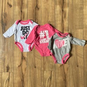 Super cute set of 3 Nike baby girl pink onesies